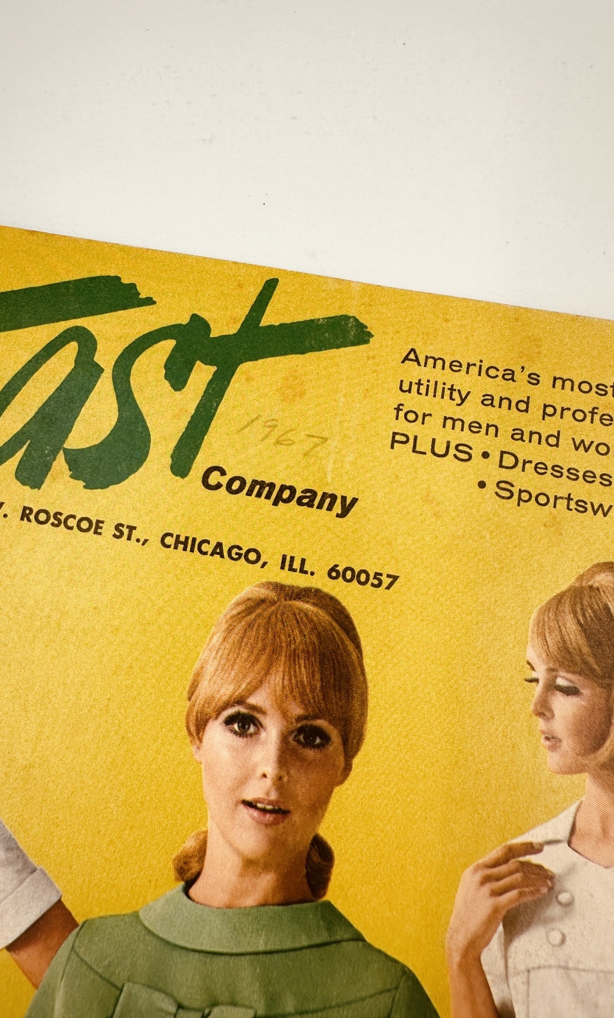 Close-up detail of the James G. Fast Catalog 1967 cover, highlighting the bold title and models wearing nurse uniforms, emphasizing professional attire from the late 1960s.