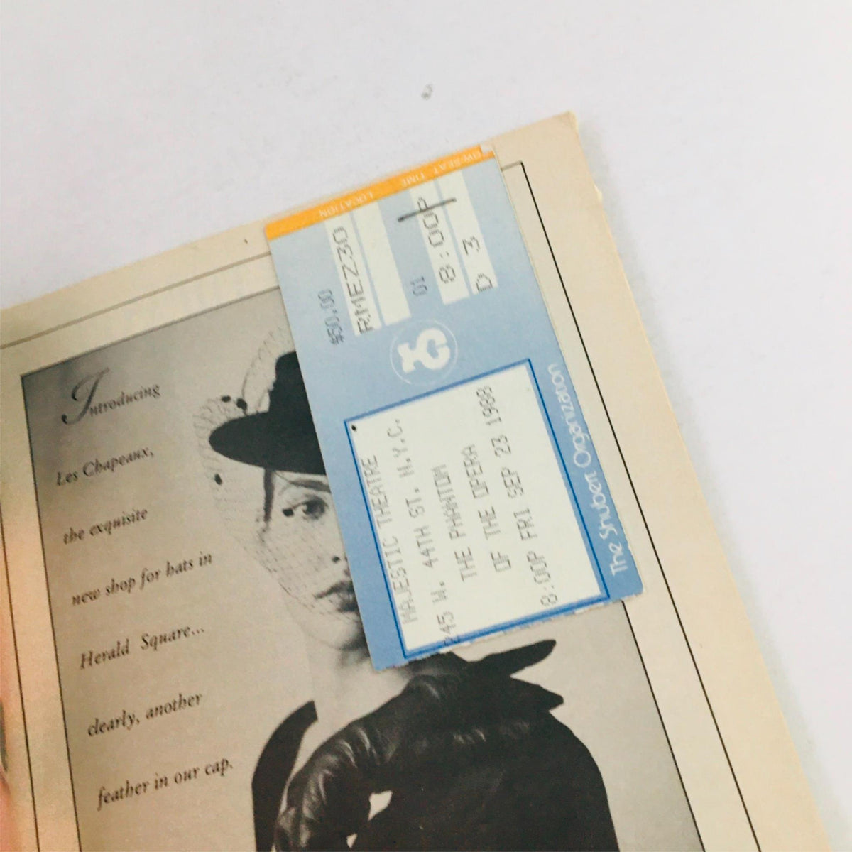 Close-up of a 1988 Playbill Phantom of the Opera featuring a ticket stub from the Majestic Theatre performance.