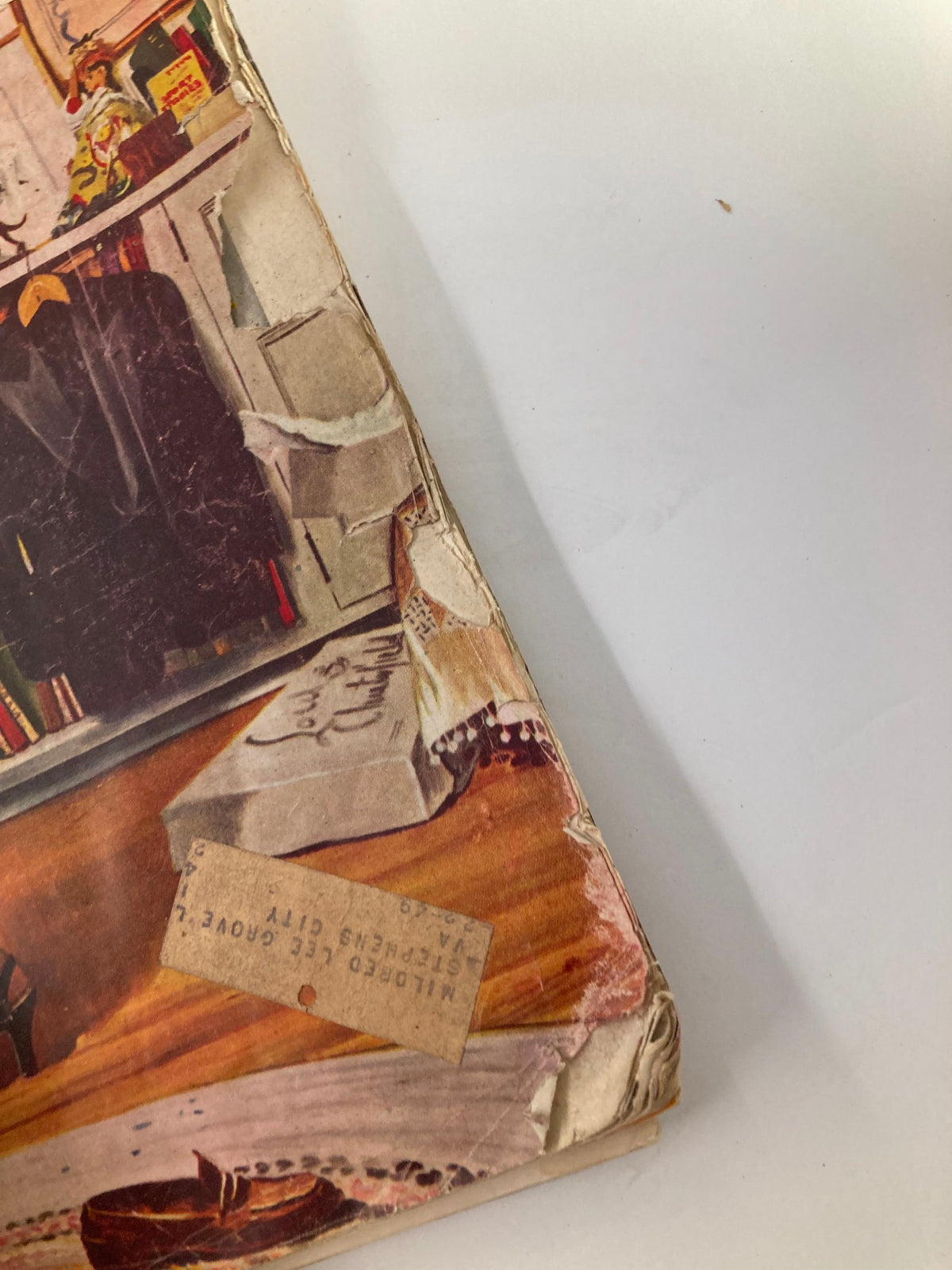 A close-up image showcasing the worn corner of The Saturday Evening Post October 16, 1948, highlighting its vintage wear including creases and a small address label.