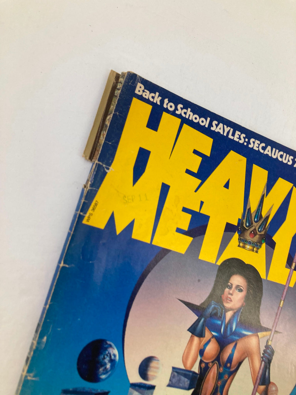 Close-up view of the title and part of the cover of VTG Heavy Metal Magazine October 1984 Vol 8 #7, highlighting the iconic logo and a beautiful fantasy illustration.