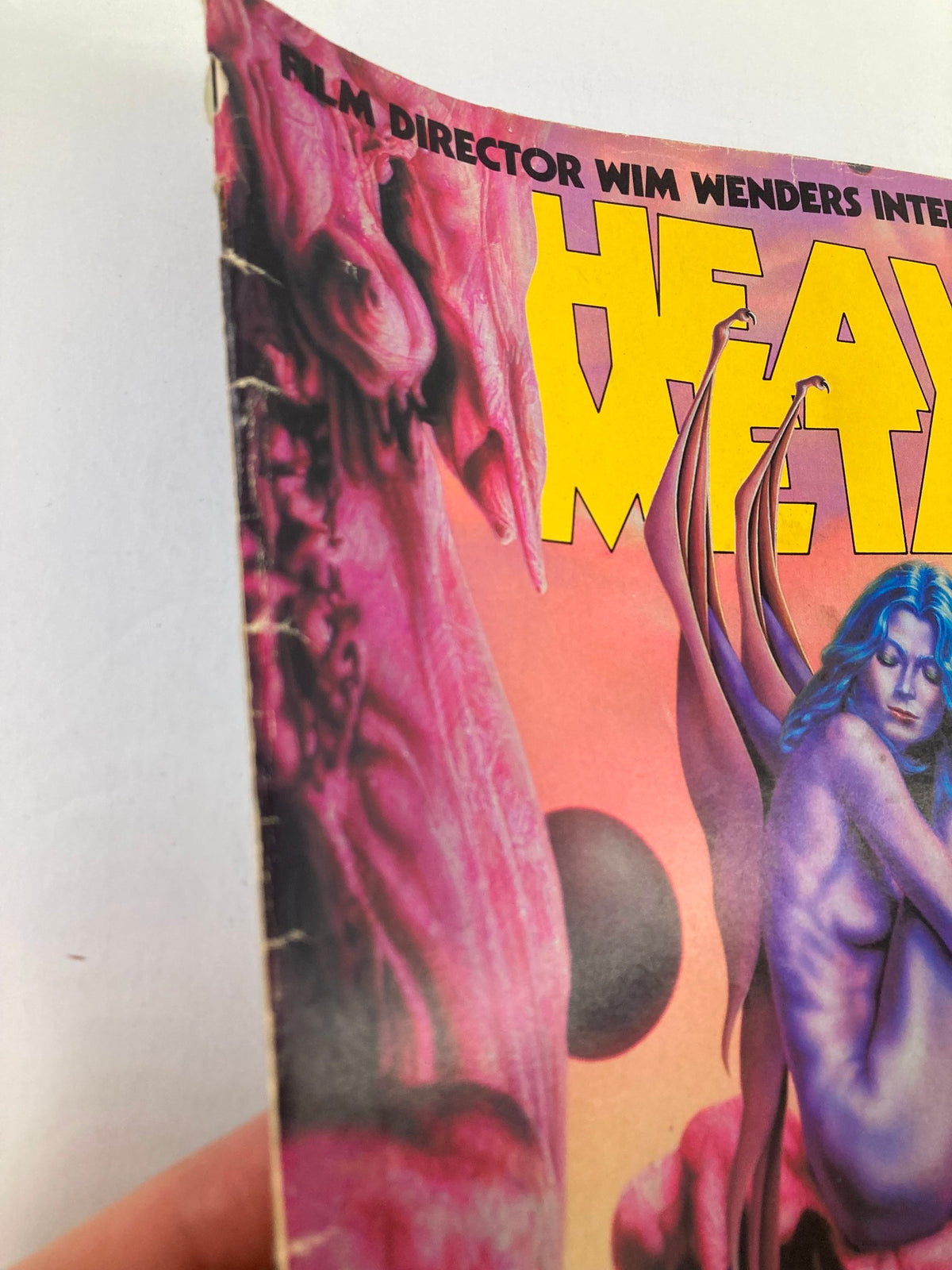 Close-up side view of VTG Heavy Metal Magazine June 1983 Vol 7 #3 Front Cover highlighting the intricate details of the cover art by Barclay Shaw, with an emphasis on the surreal elements.