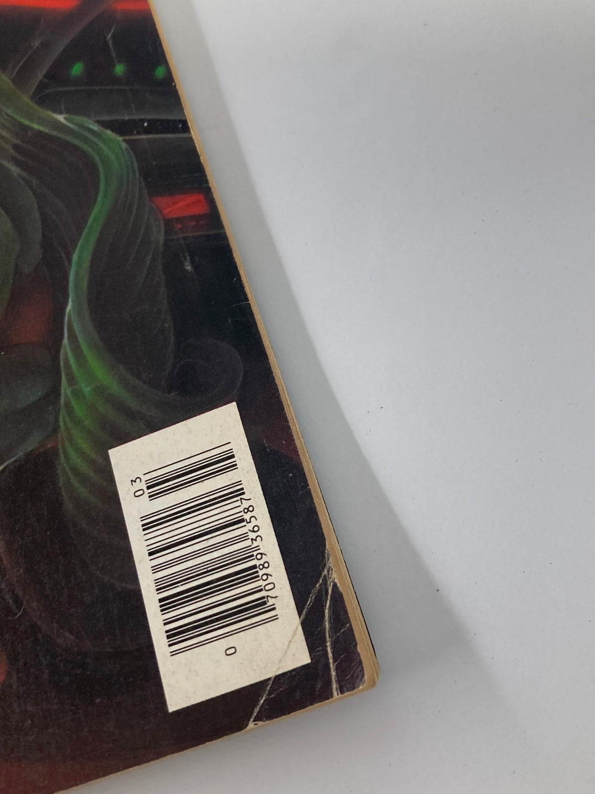 Detailed view of the back cover of VTG Heavy Metal Magazine March 1983 Vol 6 #12 featuring a barcode and minor wear, with no label.