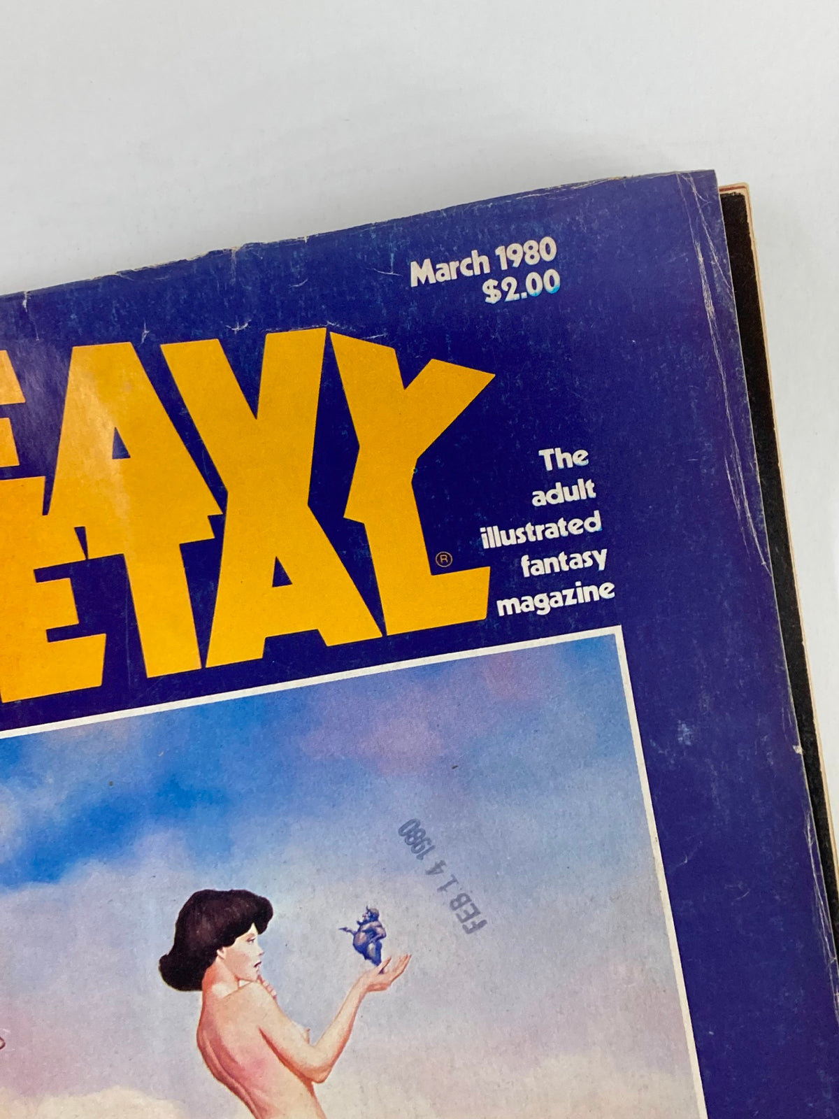 Close-up view of the front cover of VTG Heavy Metal Magazine March 1980 with the title prominently displayed, highlighting the adult illustrated fantasy theme.