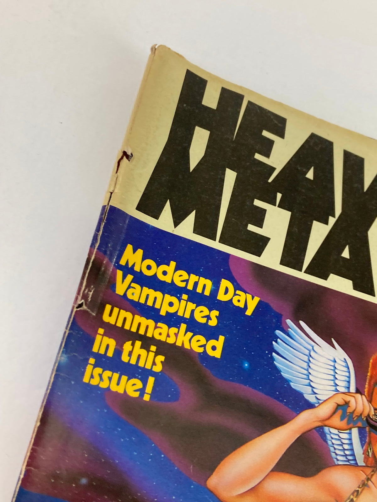 Close-up of the cover of VTG Heavy Metal Magazine January 1984, Vol 7 #10 showcasing the title and subtitle 'Modern Day Vampires unmasked in this issue!'