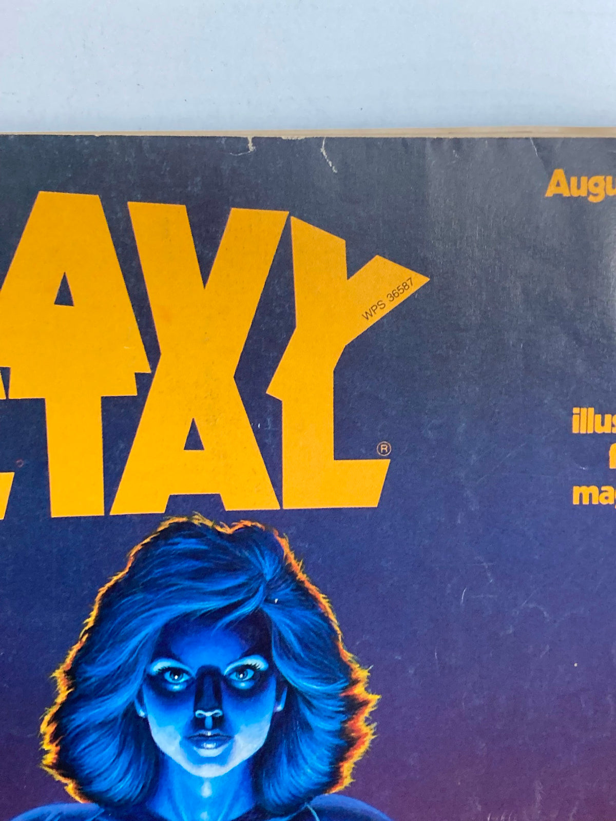 Front cover of VTG Heavy Metal Magazine August 1984, illustrated by Steven Sabella, showcasing a vibrant blue-haired female character against a bold yellow title.
