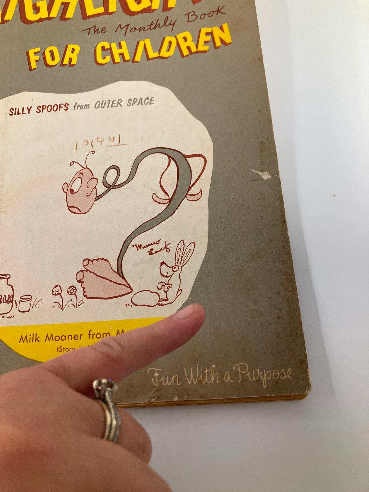Close-up of the VTG Highlights Magazine August 1956 cover, showing details of the title 'Milk Moaner from Mars' along with playful illustrations and the phrase 'Fun With a Purpose'.