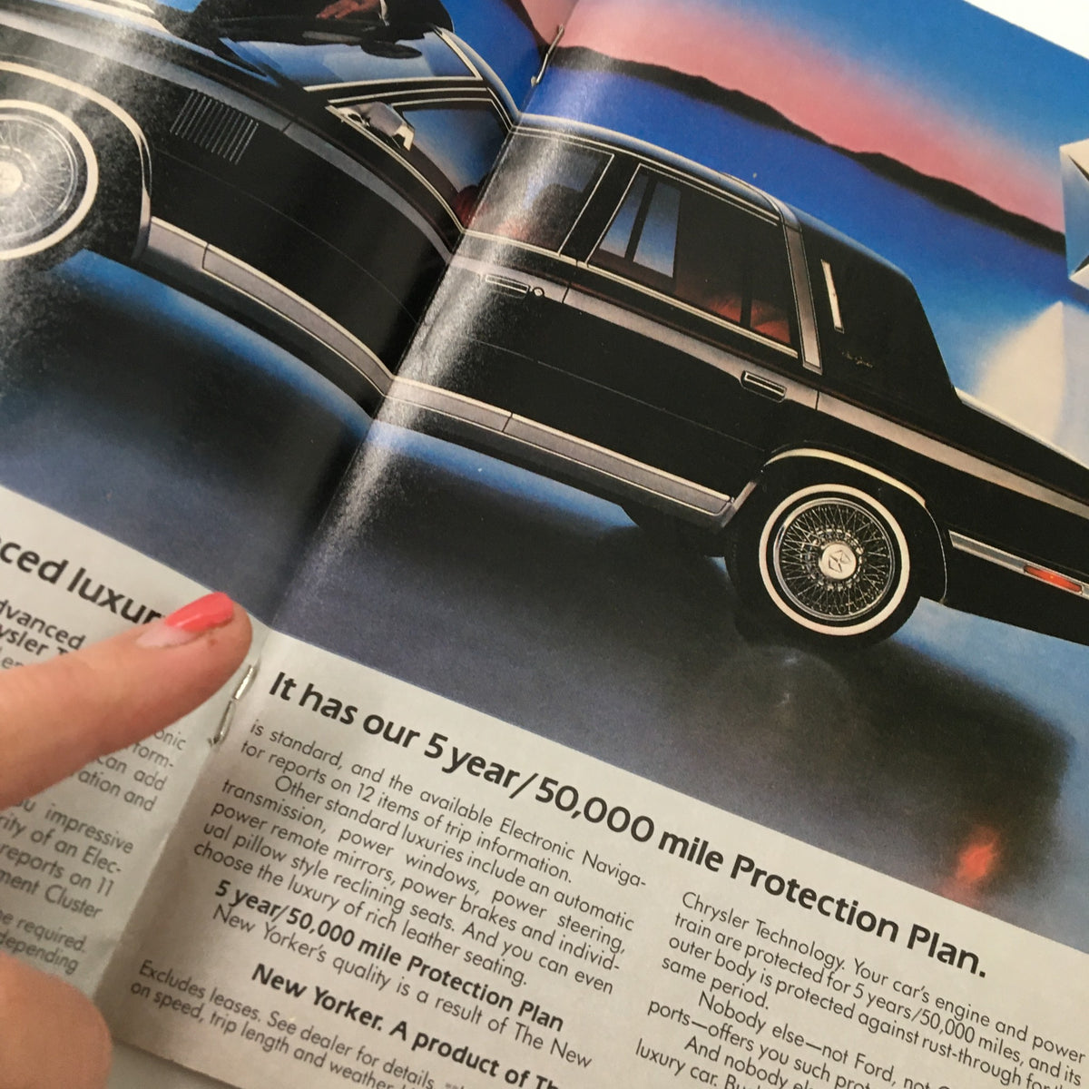 Image of an advertisement from the 1982 Playbill for 'A Flea in Her Ear' by Donald Ewer, featuring a luxury car with promotional text and highlighting the era's style.