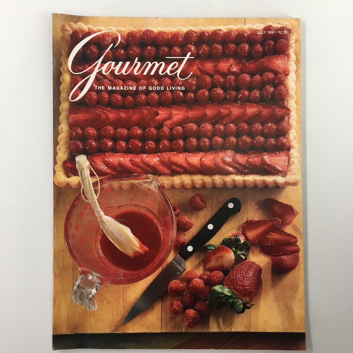 Cover image of Gourmet Magazine July 1991 featuring a beautiful Frangipane tart topped with strawberries and raspberries, accompanied by a measuring cup and a knife, representing the culinary theme of summer fruits.