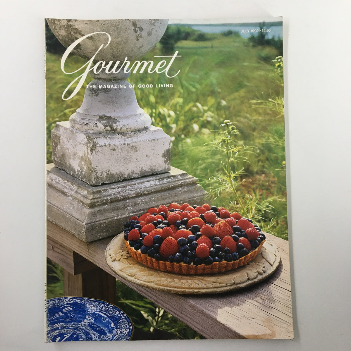 Cover of Gourmet Magazine July 1992 featuring a vibrant Red and Blue Berries All-American Tart set in a picturesque outdoor scene with lush greenery.