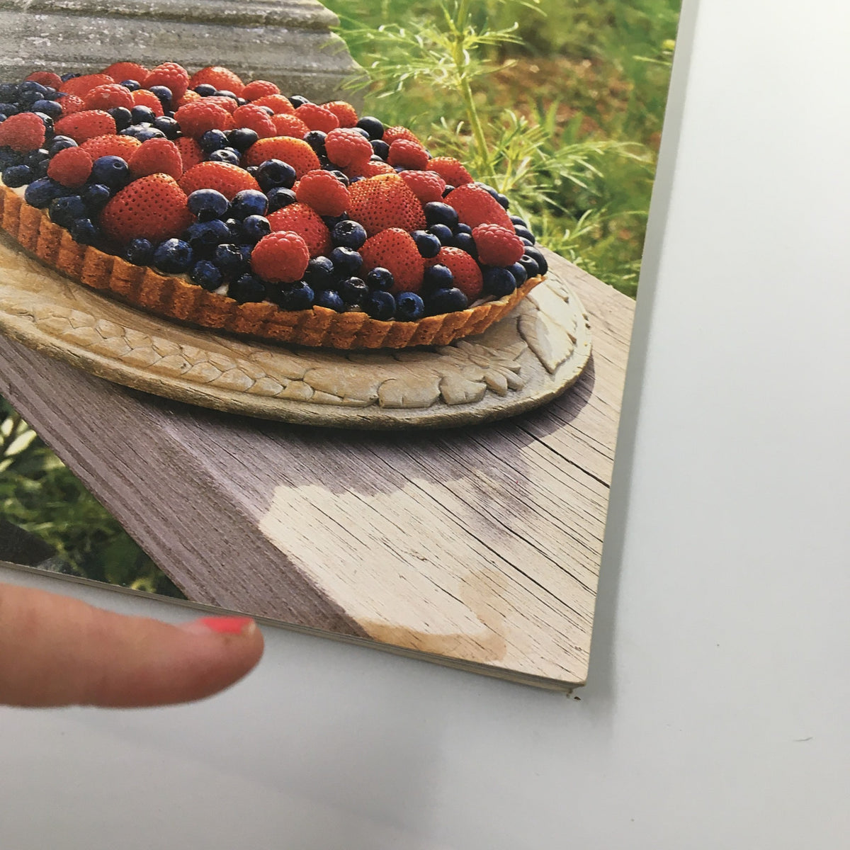 Close-up view of the Red and Blue Berries All-American Tart from the July 1992 issue of Gourmet Magazine, showcasing fresh strawberries and blueberries on a beautifully crafted crust.
