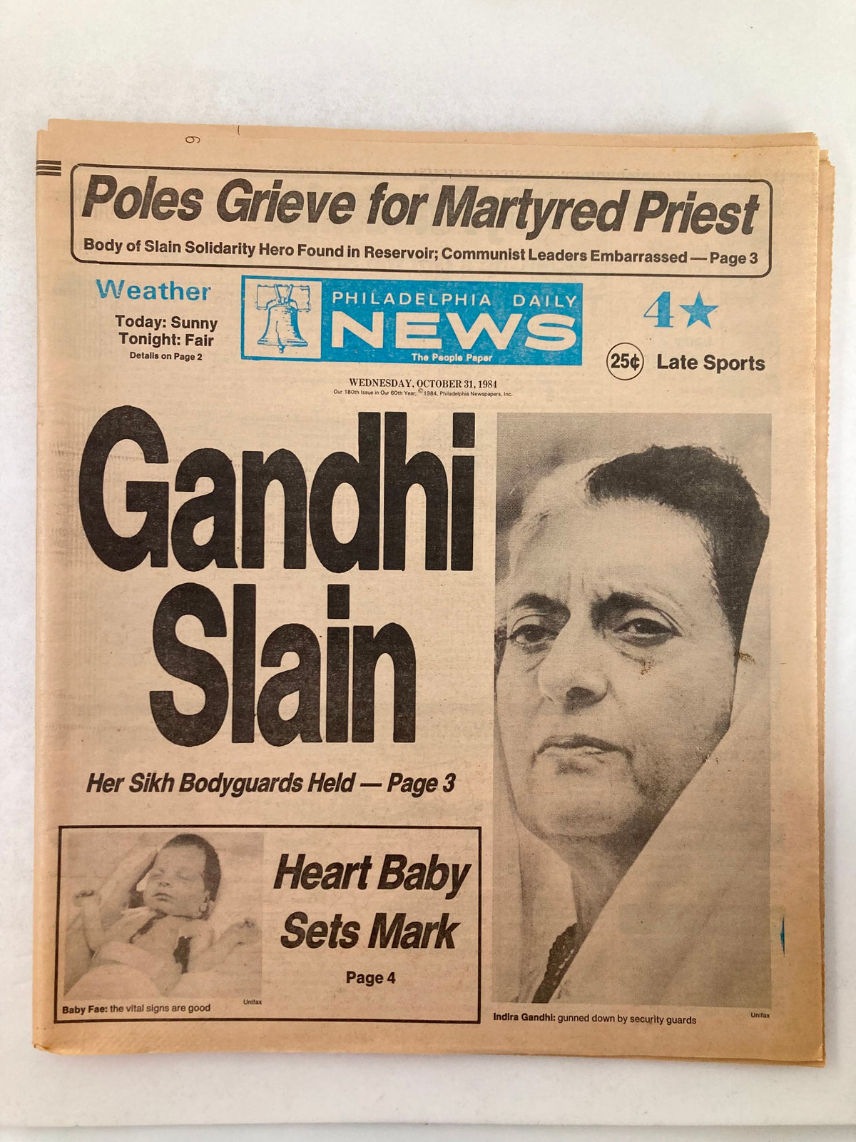 Philadelphia Daily News Tabloid from October 31, 1984, featuring the headline 'Gandhi Slain' about Indira Gandhi's assassination, with a photograph of her and related articles on the front page.