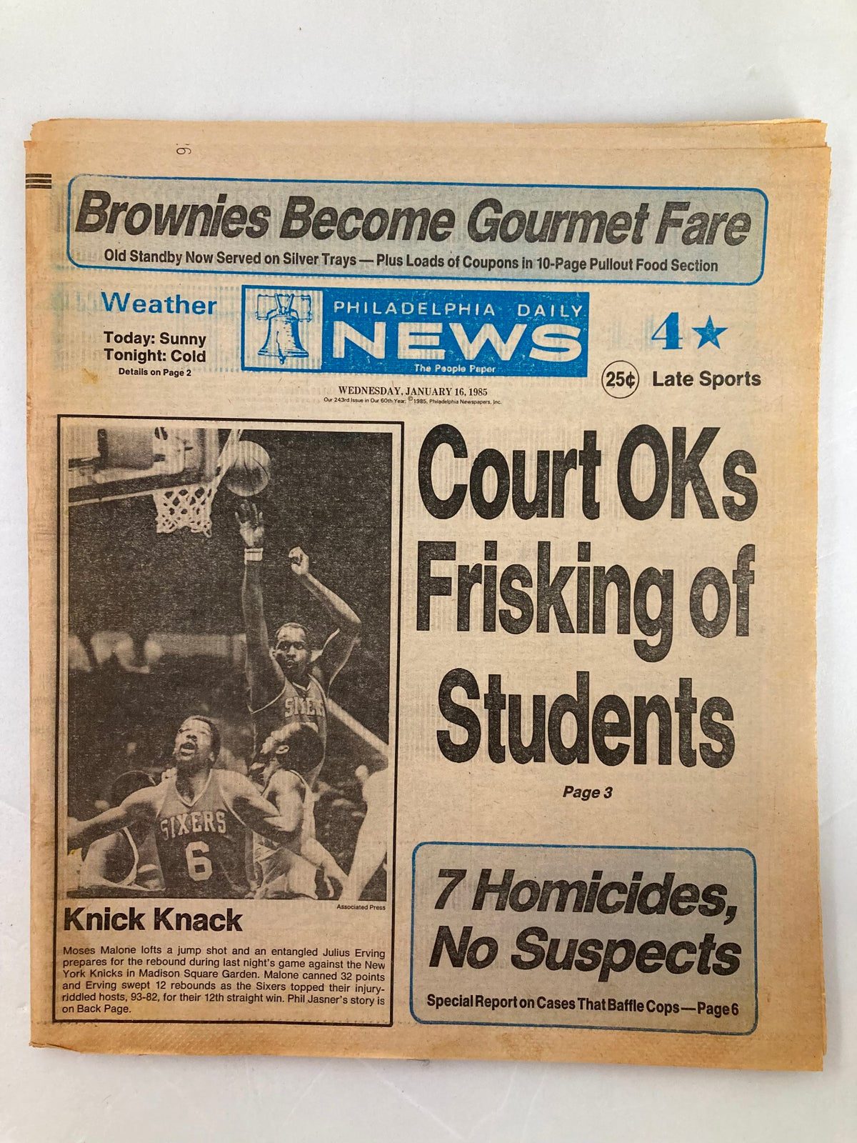 Philadelphia Daily News Tabloid from January 16, 1985, featuring Moses Malone and Julius Erving in action during an NBA game, highlighting significant moments in basketball history.