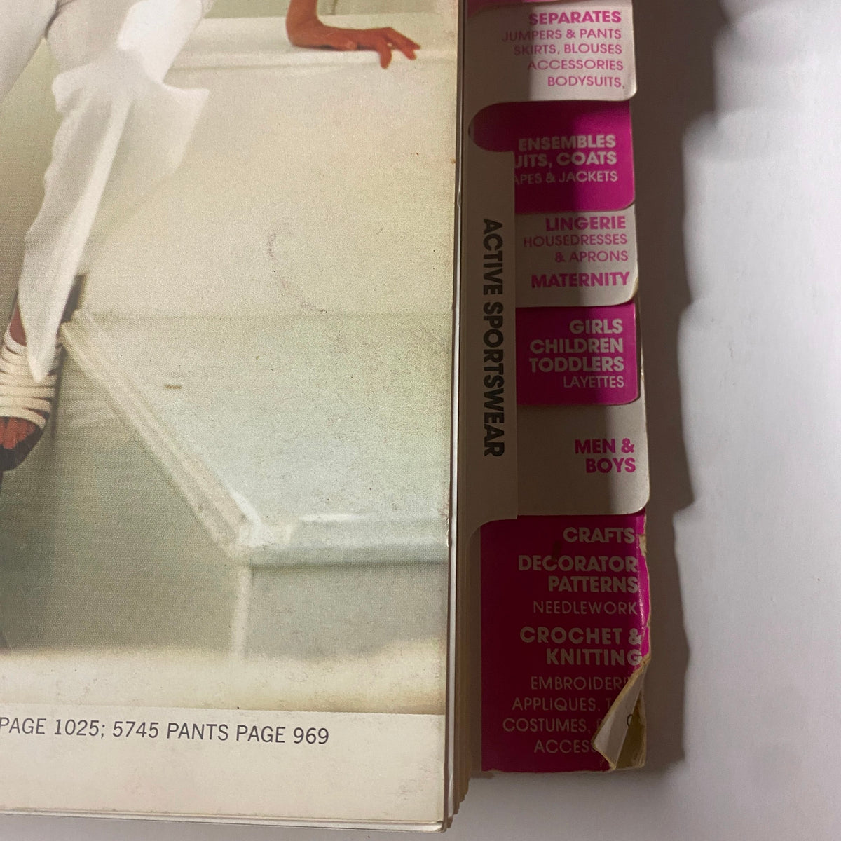 Side view of the 1973 July Simplicity Catalog emphasizing sections for active sportswear, crafts, and children's patterns alongside fashion sewing ideas.