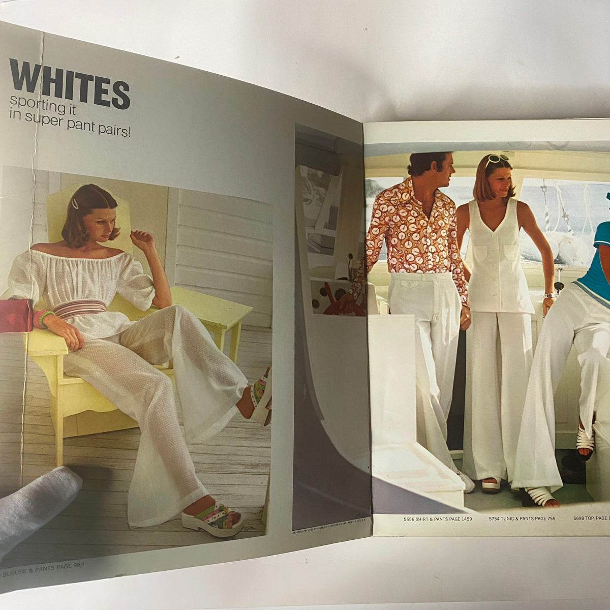1973 July Simplicity Catalog showcasing summer fashion patterns, featuring women in stylish white outfits including pants and blouses.