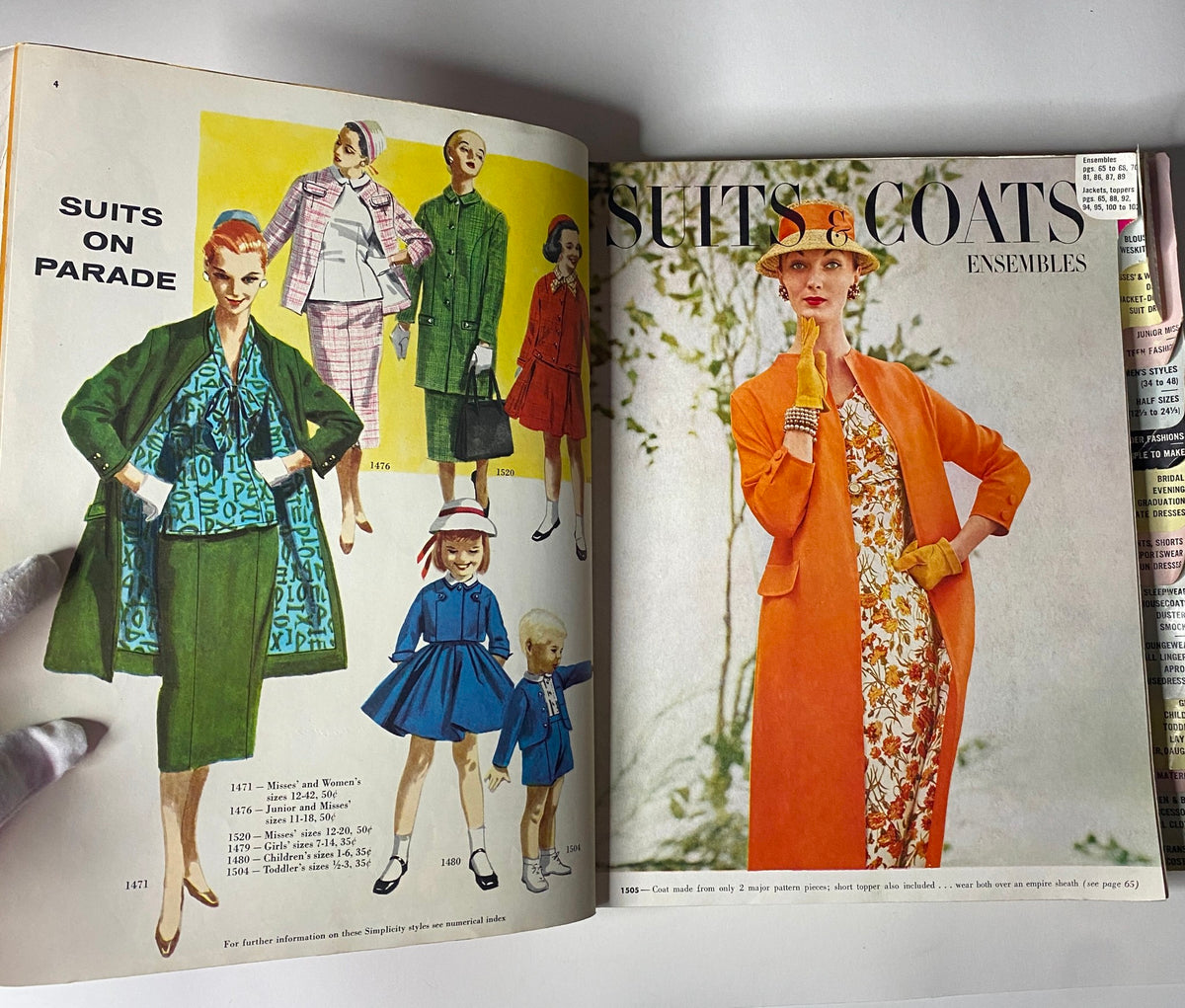 Interior page of the 1956 May Simplicity Sewing Pattern Catalog, illustrating various suits and coats for women and children, showcasing 1950s fashion ensembles.