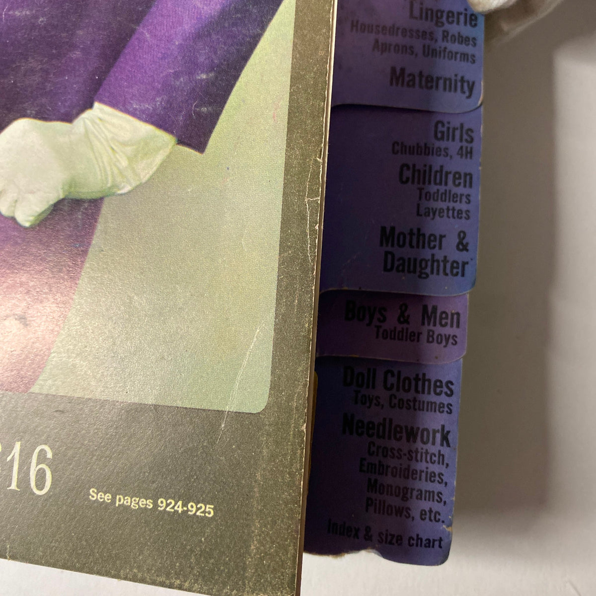 Detailed view of the 1964 October Simplicity Fall Catalog featuring fashion categories for women, children, and needlework along the edges of the catalog.