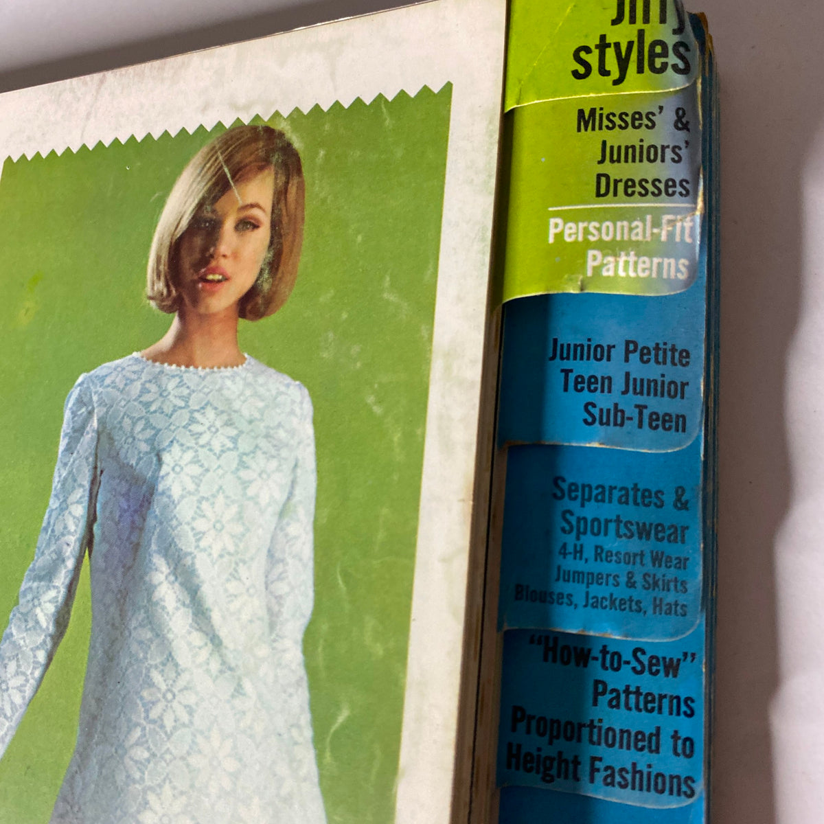Cover of the 1965 May Simplicity Catalog featuring a model in a blue lace dress, highlighting Jiffy Styles, Misses', and Juniors' Dresses.