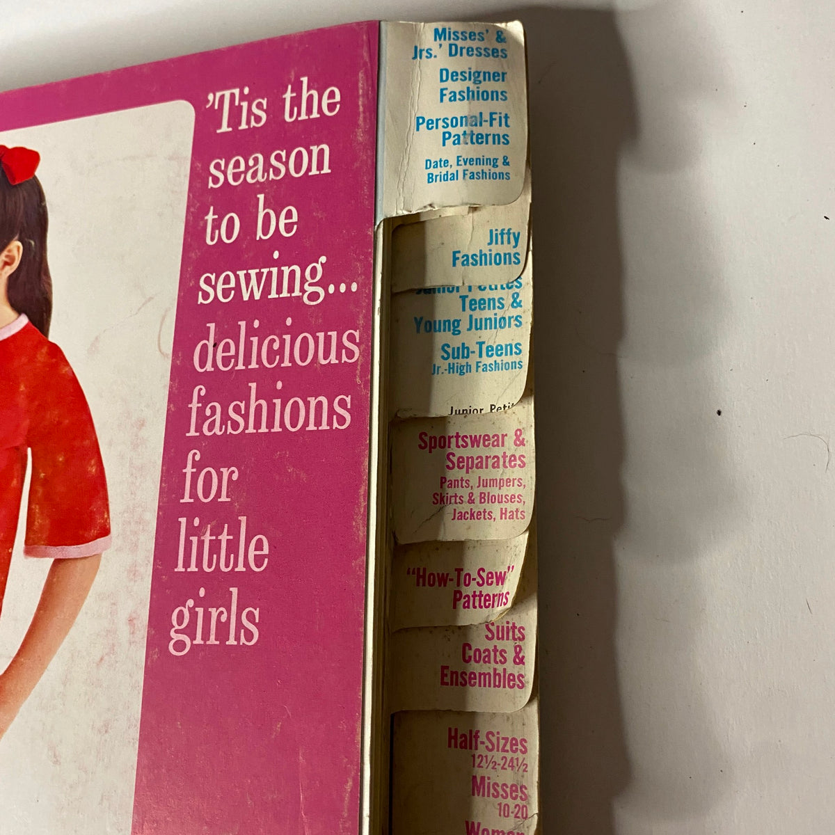 Side view of the 1967 January Simplicity Catalog, displaying the section titled 'Tis the Season to Be Sewing' with tabs for various categories including Misses' Dresses and Designer Fashions.
