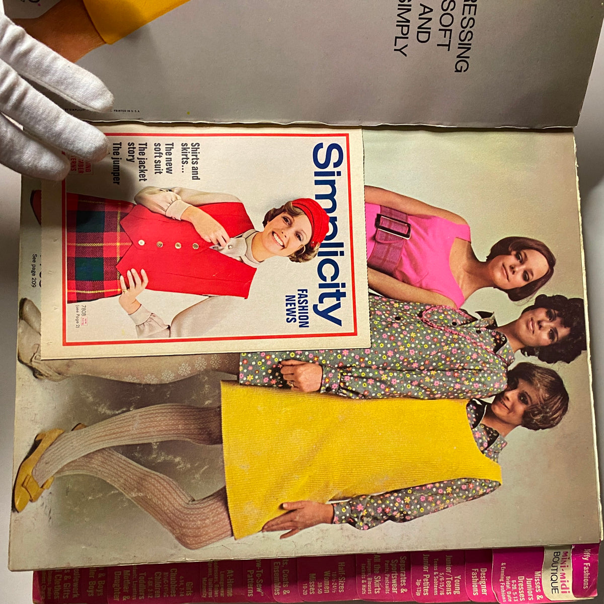 Open view of the 1968 August Simplicity Catalog, showing three models in vibrant outfits and showcasing the fashion news edition, capturing the essence of 1960s style.