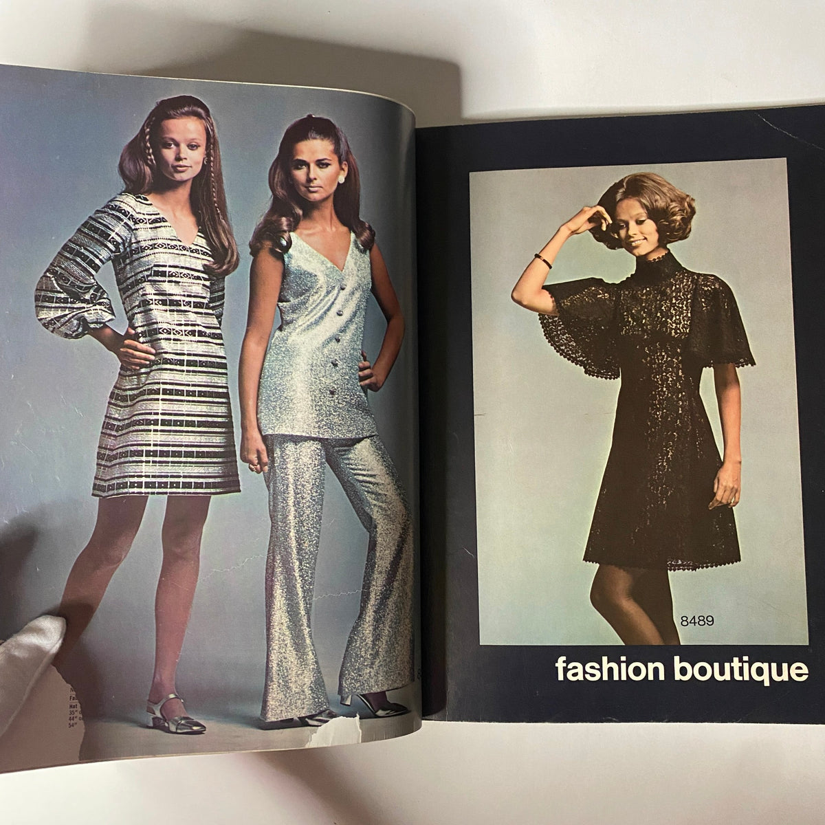 1969 Simplicity Holiday Catalog featuring stylish models in glittery two-piece outfits and elegant dresses in the 'fashion boutique' section.