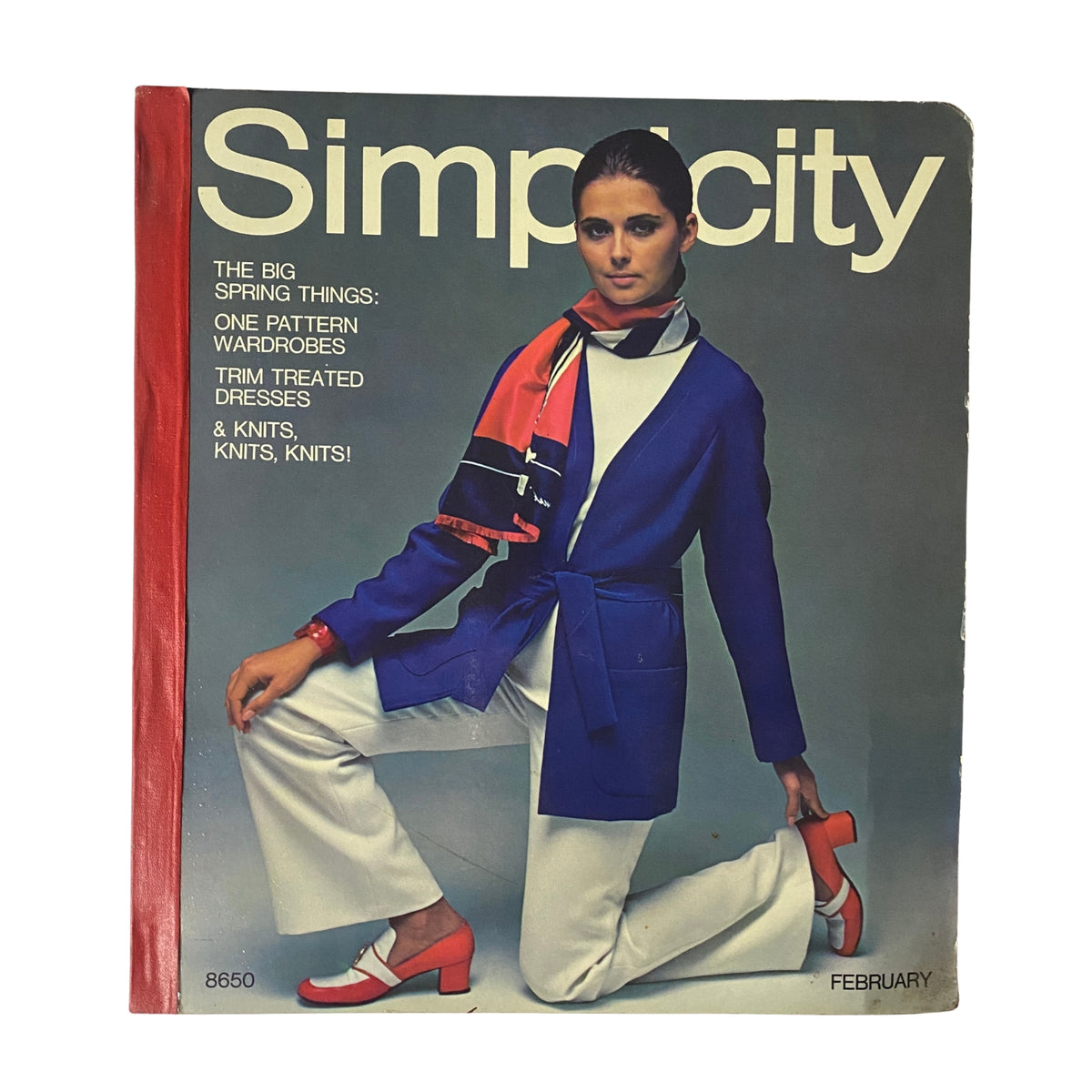 1969 February Simplicity Spring Catalog cover showcasing vibrant spring fashion. Model wearing a navy blue jacket with a scarf, emphasizing trendy patterns and styles.