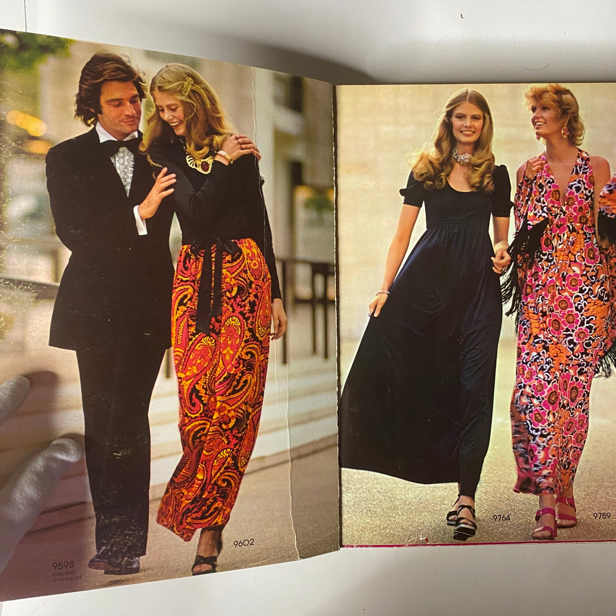 Interior spread of the 1971 January Simplicity Catalog showcasing two models, one in a floral maxi skirt and the other in a black dress, highlighting vibrant styles of the early '70s. This issue captures the spirit of contemporary fashion for young women.
