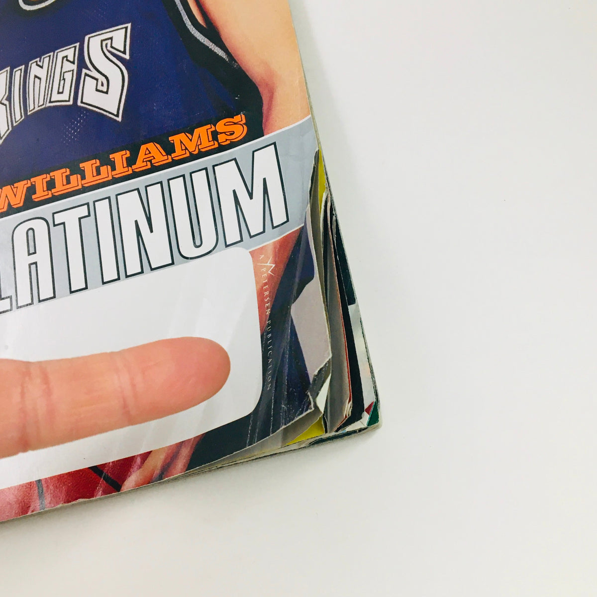 Close-up of the edge of Slam Magazine March 2000 showing Chris Webber and Jason Williams, highlighting the title 'Double Platinum' and minor wear on the magazine's spine.