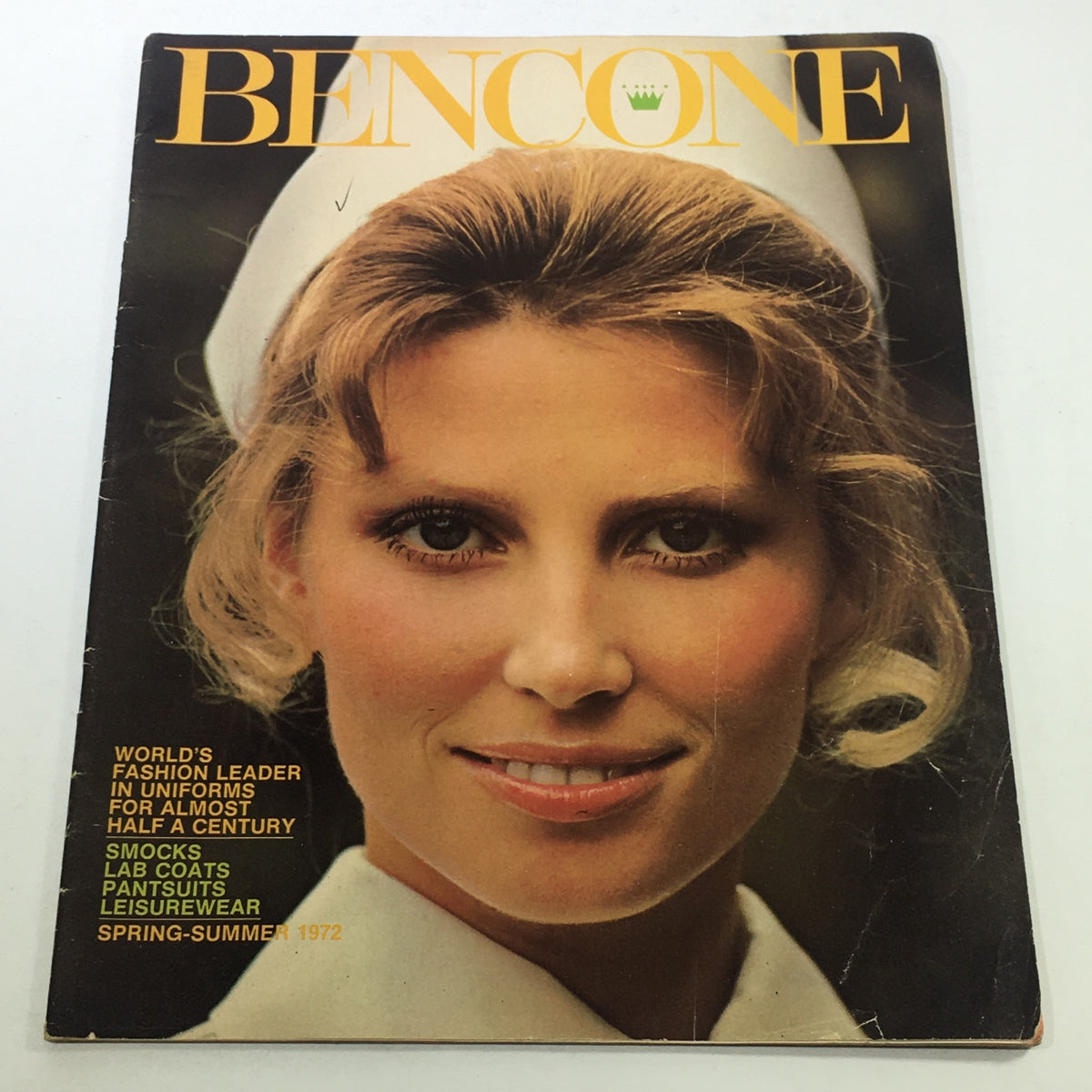 Cover of VTG Bencone Magazine: Spring Summer 1972 featuring a smiling model in a nurse uniform, showcasing 1970s fashion and styles. The magazine highlights its title as the World's Fashion Leader and includes details about uniforms and categories like smocks, lab coats, and leisurewear.