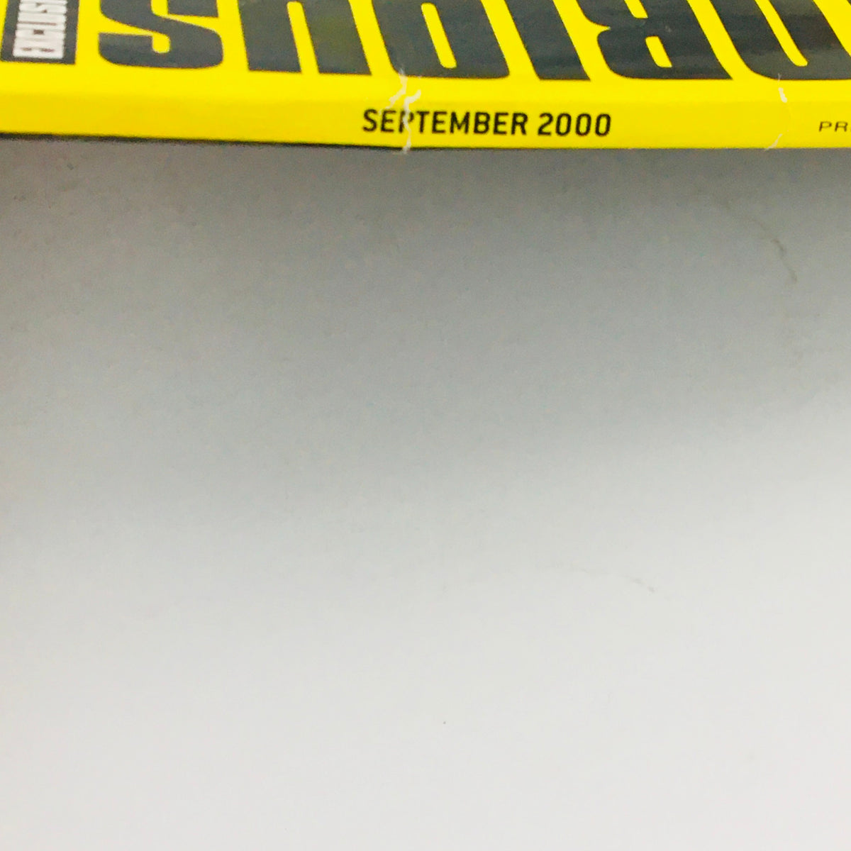 Side view of Slam Magazine September 2000, showing the title and publication date, showcasing the vintage appeal of the basketball-themed issue.