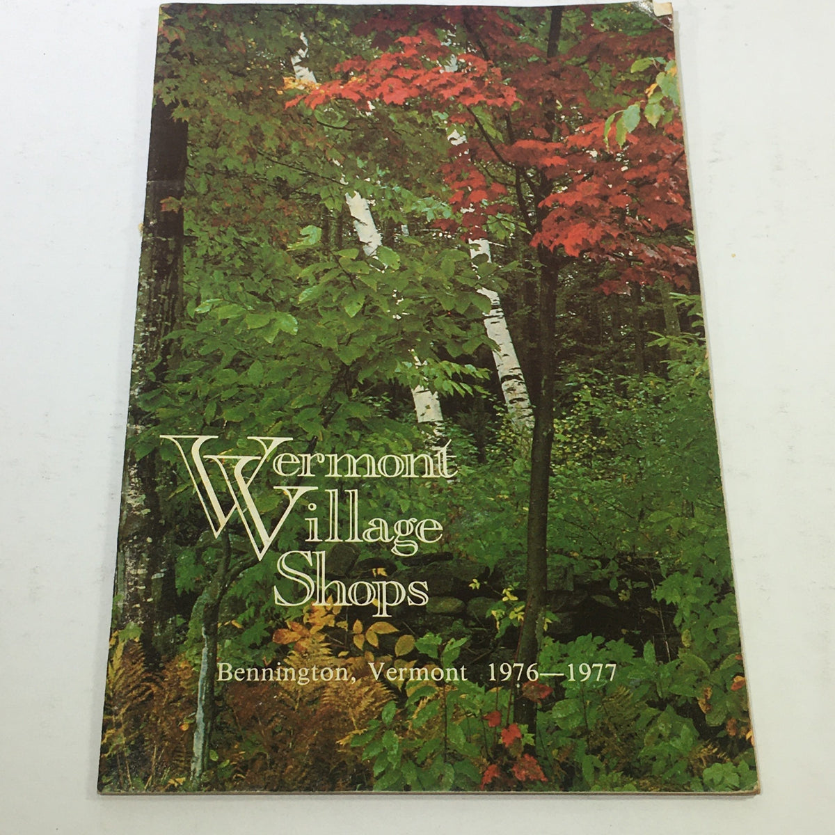 Vintage catalog cover of VTG Vermont Village Shops Catalog: 1976 - 1977 featuring vibrant autumn foliage and forest scenery from Bennington, Vermont.