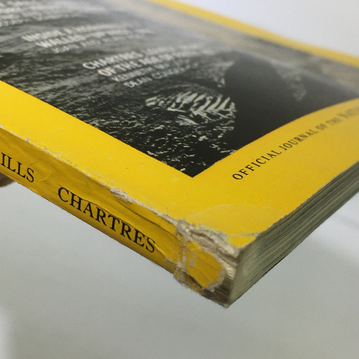 Close-up view of the spine of VTG National Geographic Magazine December 1969, showing wear and tear, highlighting its vintage condition.