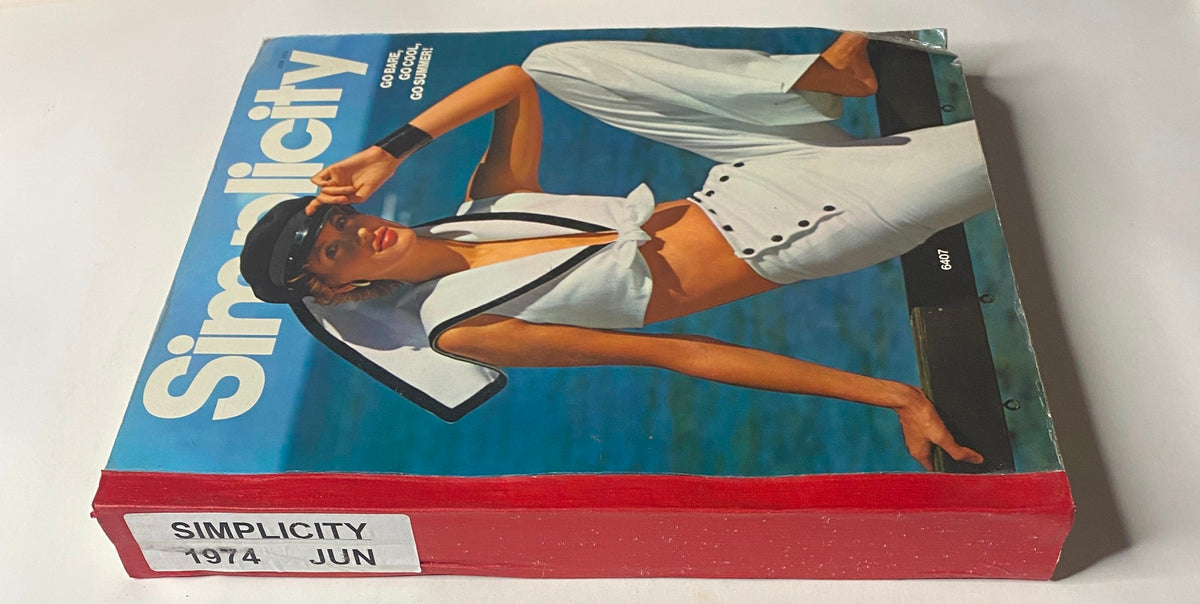 Side view of the 1974 June Simplicity Catalog, highlighting its vibrant cover featuring a model in a sailor-style outfit. A must-have resource for sewing and fashion inspiration.