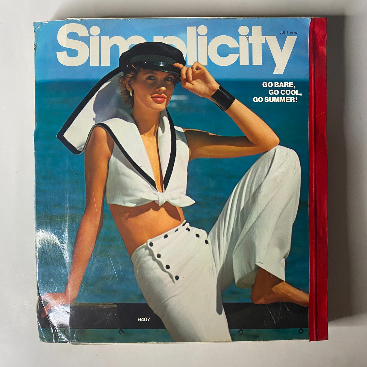1974 June Simplicity Catalog cover featuring a stylish model in summer attire, promoting casual and chic summer fashion.