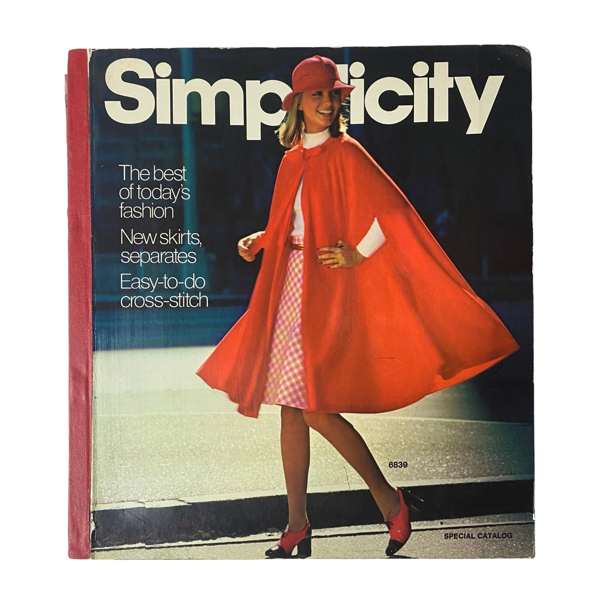 1975 Simplicity Special Catalog featuring a woman in a stylish red cape and matching hat, showcasing the best of mid-1970s fashion with patterns for skirts and separates.