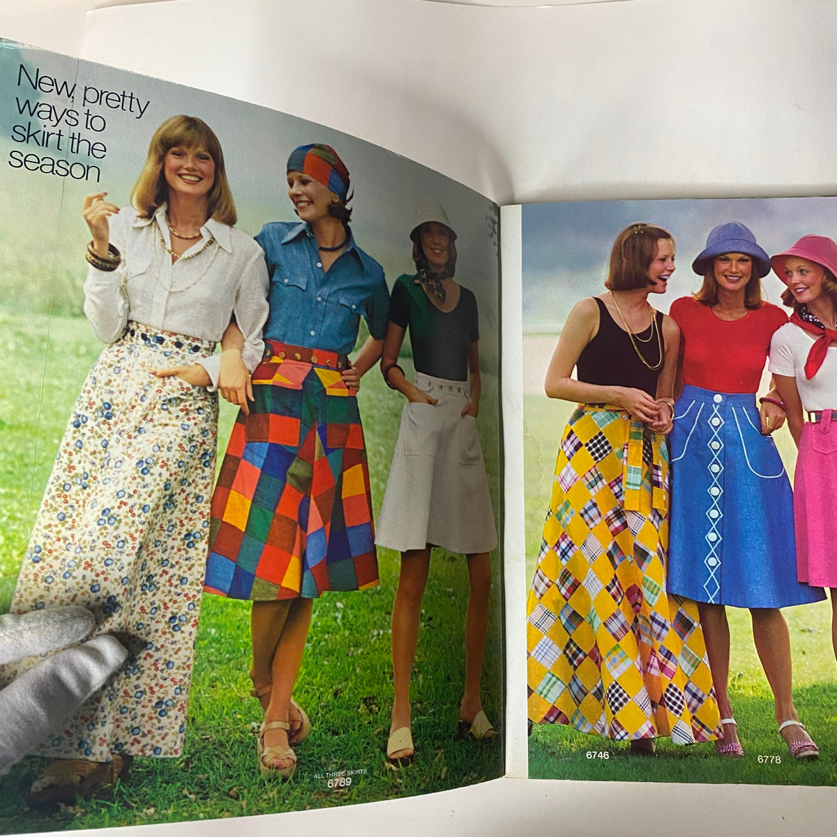 Group of women modeling colorful skirts from the 1975 Simplicity Special Catalog, showcasing trendy fashion styles for the season.