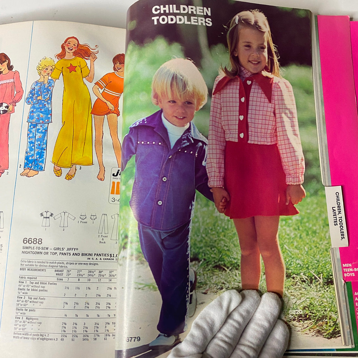 Children's fashion showcase from the 1975 June Simplicity Catalog. Features a boy and girl in stylish outfits, highlighting toddler apparel trends of the 1970s, with the title '1975 June Simplicity Catalog Sewing Pattern Giant Store Counter Book Fashion'.