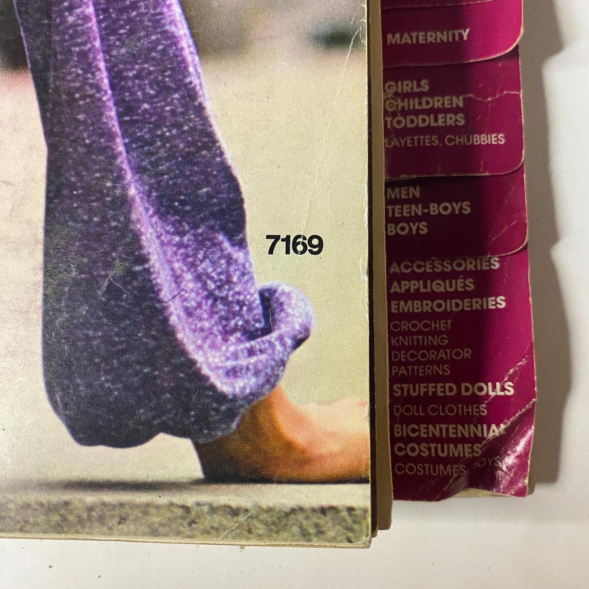 1975 November Simplicity Catalog page featuring close-up details of a purple outfit, illustrating the unique style of the era.