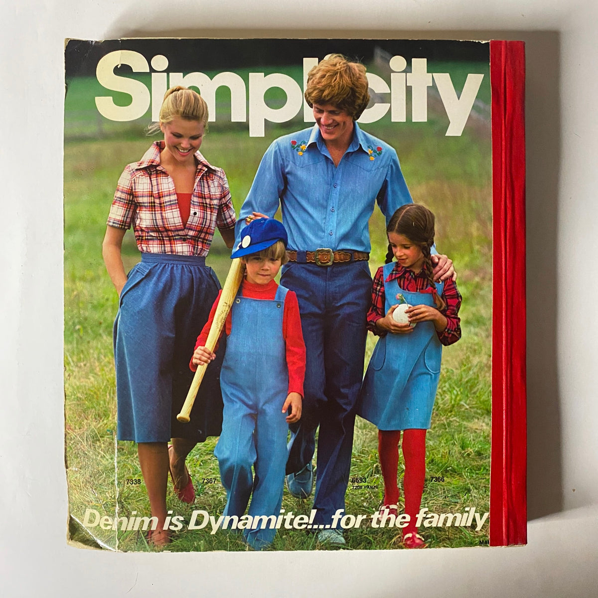 Cover of the 1976 March Simplicity Catalog showcasing denim family outfits. Highlights various sewing patterns reflecting 1970s fashion trends.