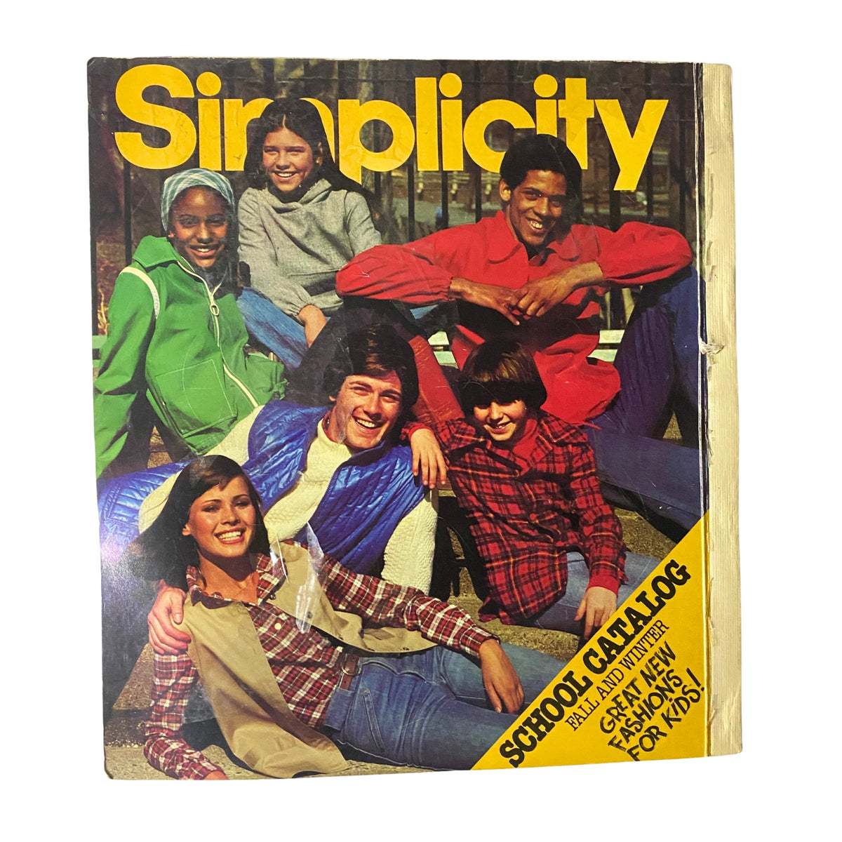 Cover of the 1977 Simplicity Fall Catalog featuring a group of teenagers in stylish 1970s attire, promoting new fashion patterns for children and adults.