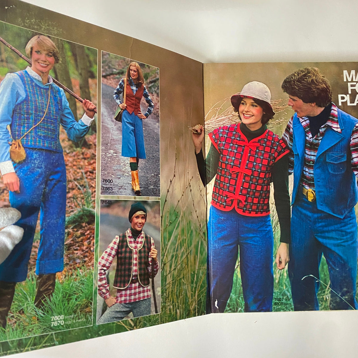 Interior page of the 1976 October Simplicity Sewing Pattern Catalog featuring plaid outfits modeled by a group, showcasing different styles and patterns conducive to autumn fashion.