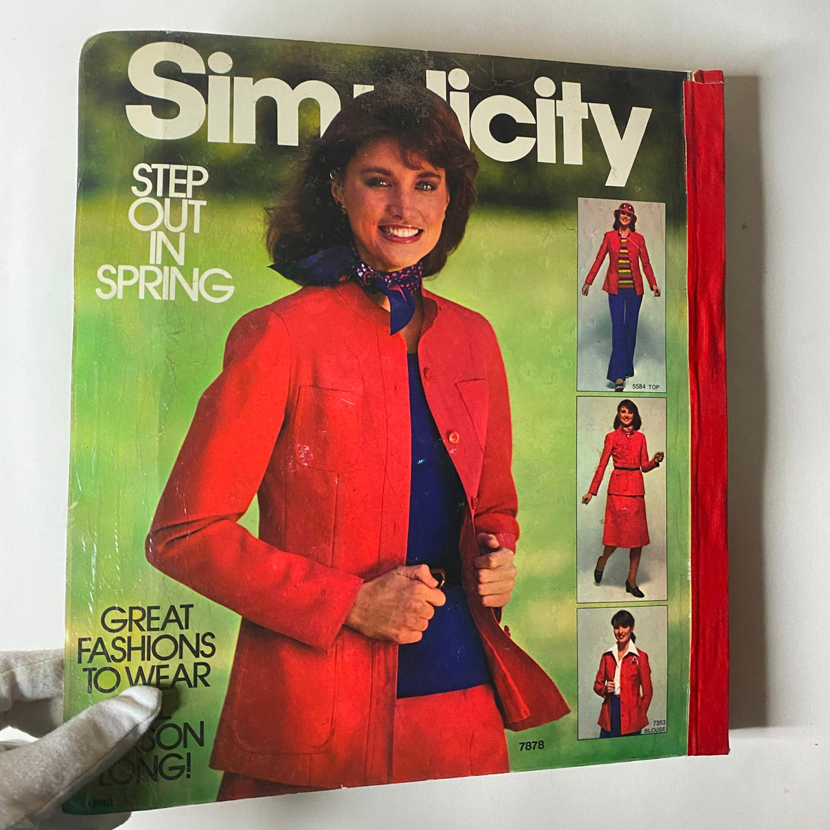 1977 April Simplicity Sewing Pattern Catalog featuring a stylish model in a red jacket and various outfit options, showcasing vintage fashion trends for spring.