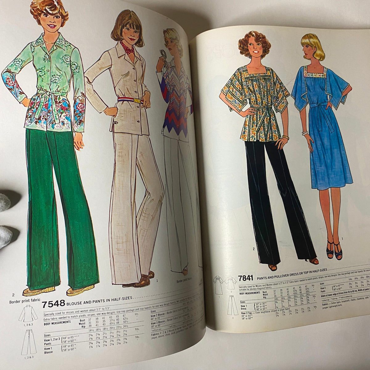 Illustration from the 1977 March Simplicity Sewing Pattern Catalog showcasing stylish blouse and pants patterns for women, featuring vibrant colors and detailed designs, ideal for vintage fashion enthusiasts.