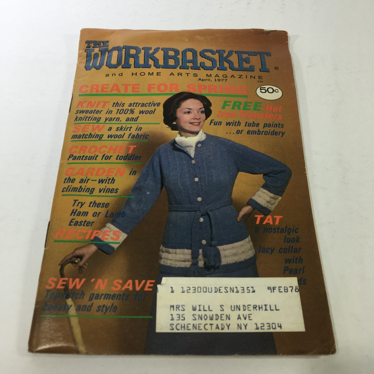 Cover of the VTG The Workbasket & Home Arts Magazine April 1977 featuring a woman wearing a knitted outfit. It highlights various crafts including knitting, sewing, crocheting, gardening, and additional recipes.