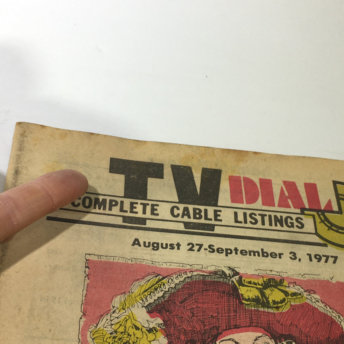 Close-up view of the VTG TV Dial August 27-September 3 1977 Complete Cable Listings, highlighting the title and date, revealing the vintage charm and wear of the publication.