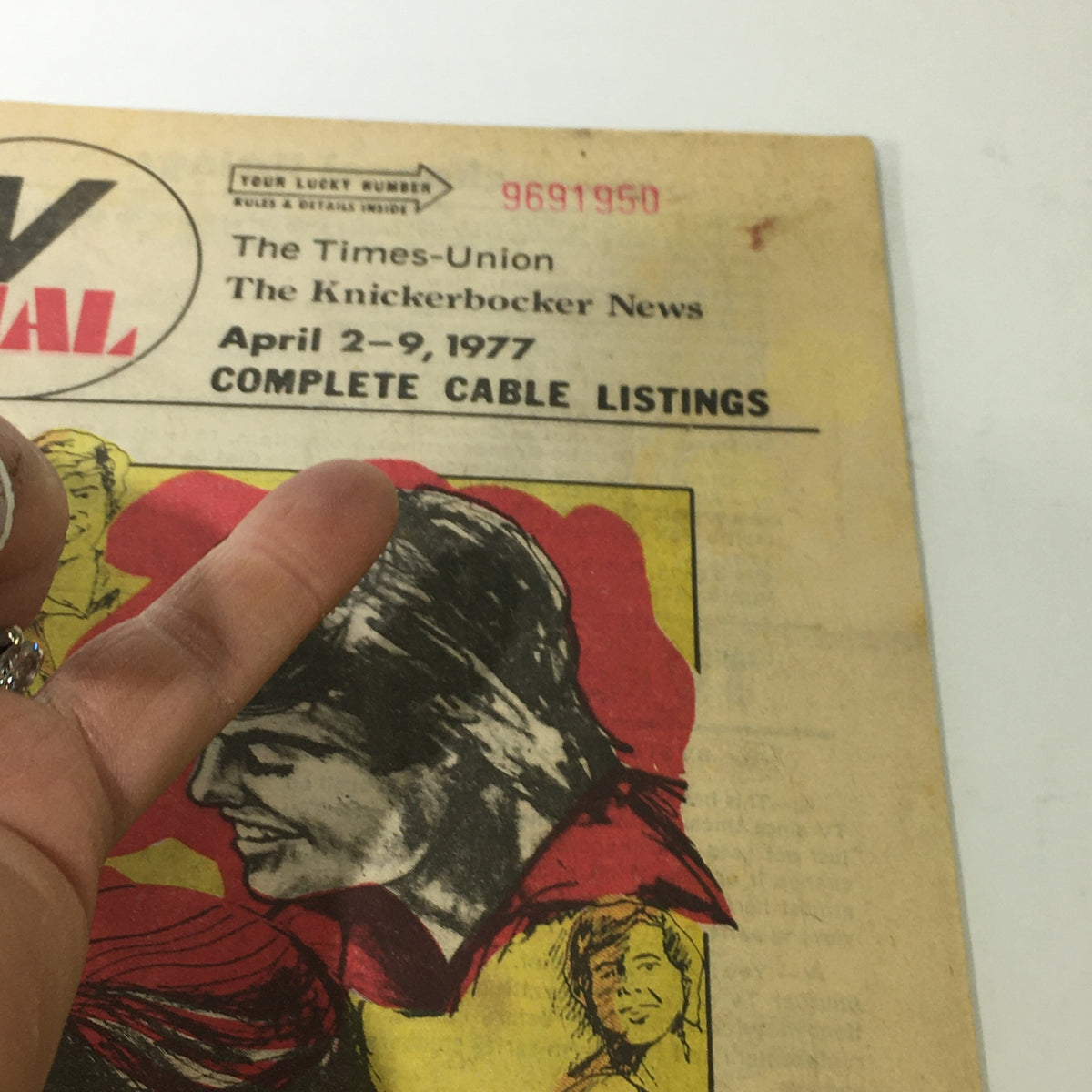 Close-up view of the VTG TV Dial Complete Cable Listings April 2-9 1977 illustrating characters from 'Donny & Marie' with a hand showing the magazine's binding.