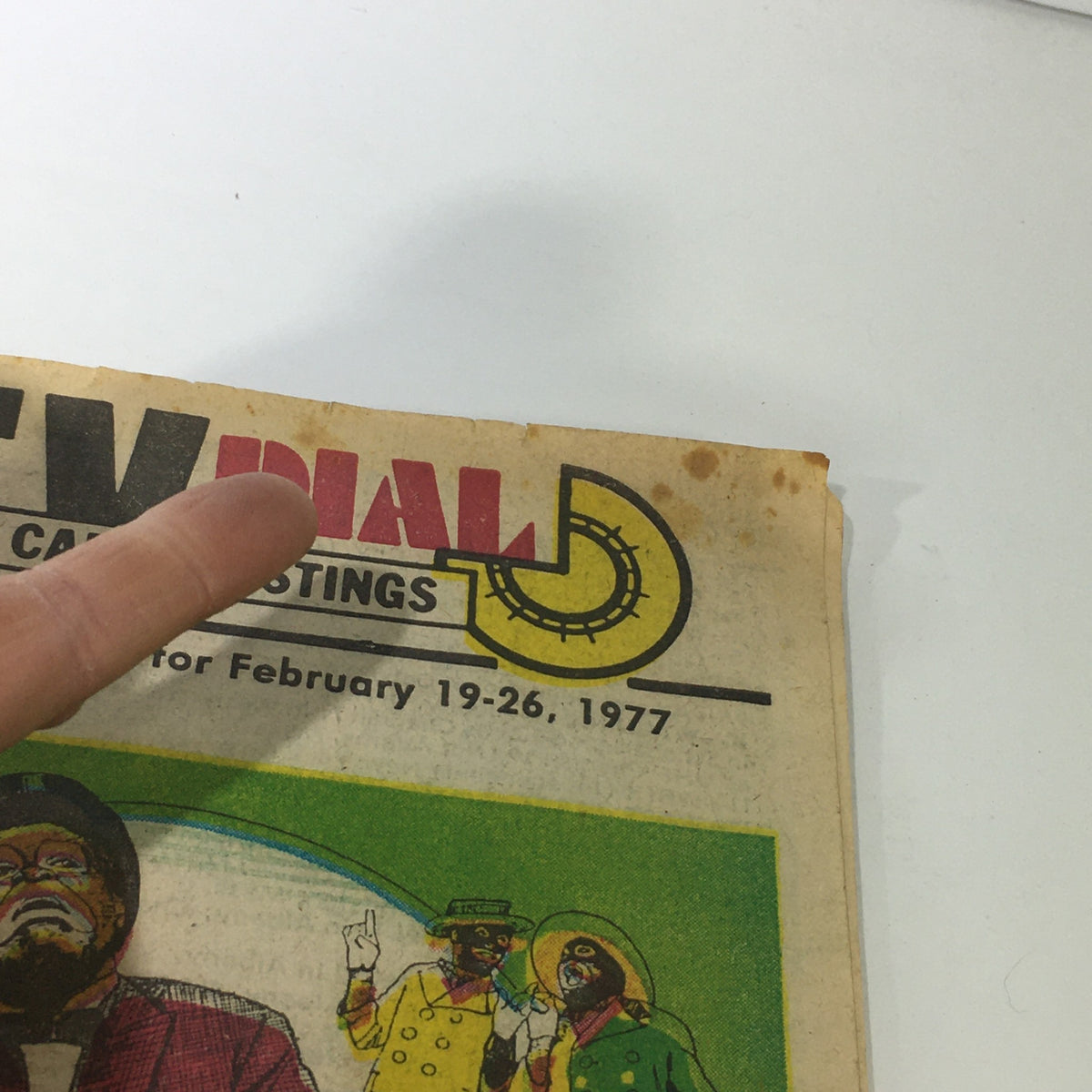Detail of VTG TV Dial Complete Cable Listings February 19-26 1977, highlighting the title and worn edges of the magazine.