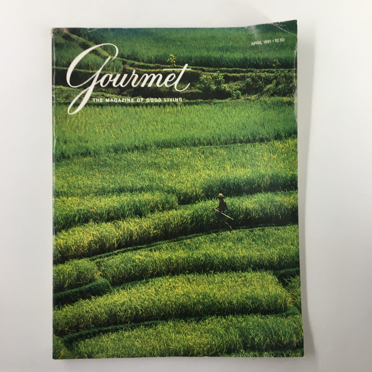 Cover of Gourmet Magazine April 1991 featuring 'The Emerald Geometry of Rice Fields' with lush green rice paddies and a farmer working in the fields.