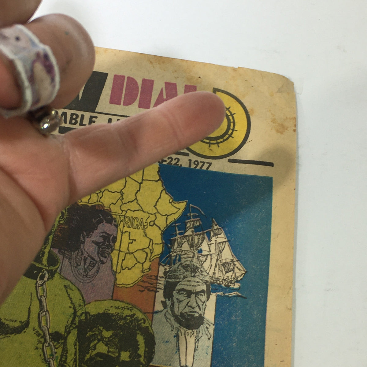 Close-up of the front cover of the VTG TV Dial Complete Cable Listings January 15-22 1977 'Roots' ABC Novel showing vibrant colors and character illustrations along with signs of wear.