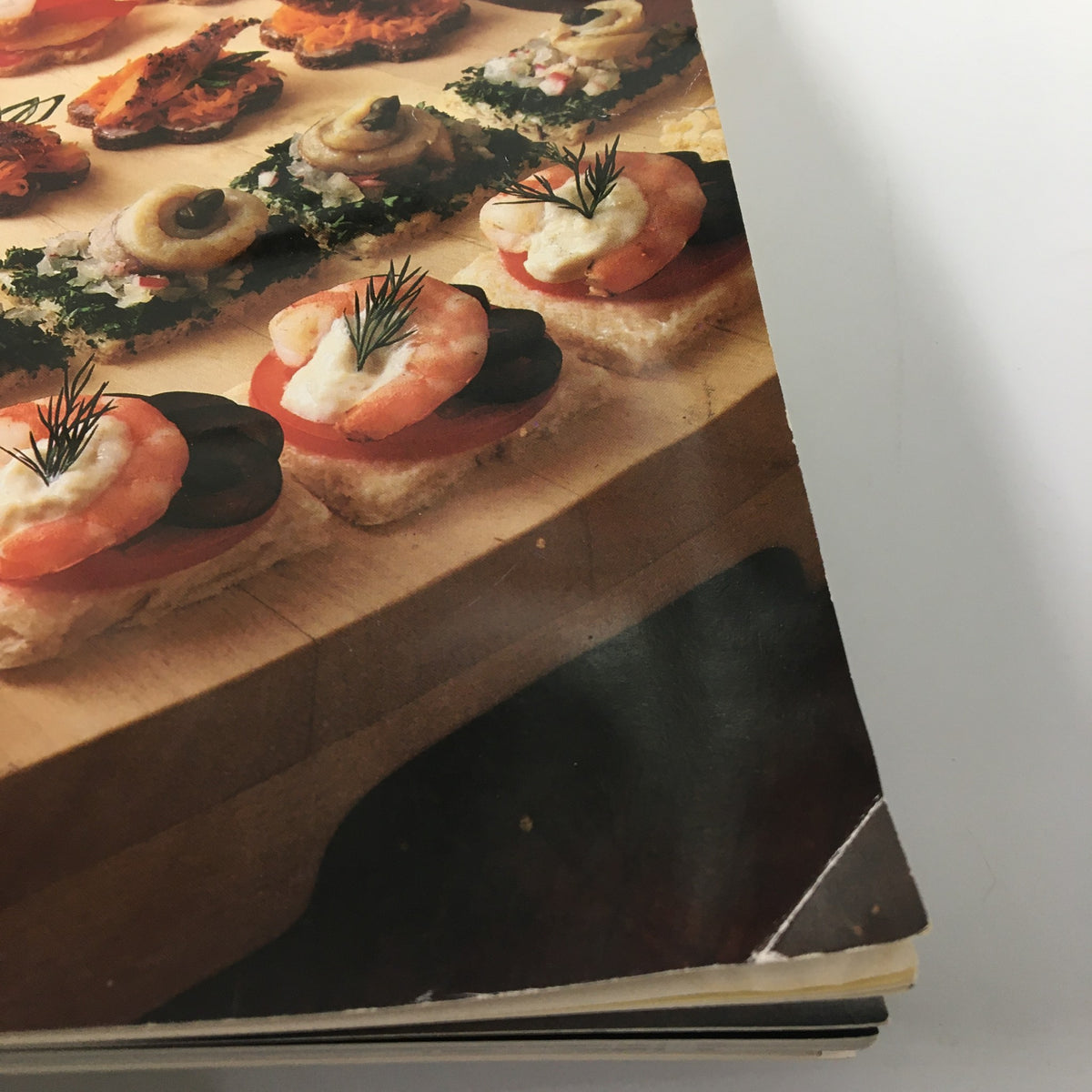 Gourmet Magazine June 1991 featuring a beautifully arranged platter of appetizers including shrimp, capers, and colorful garnishes, showcasing culinary delights from the Saint-Tropez Peninsula.