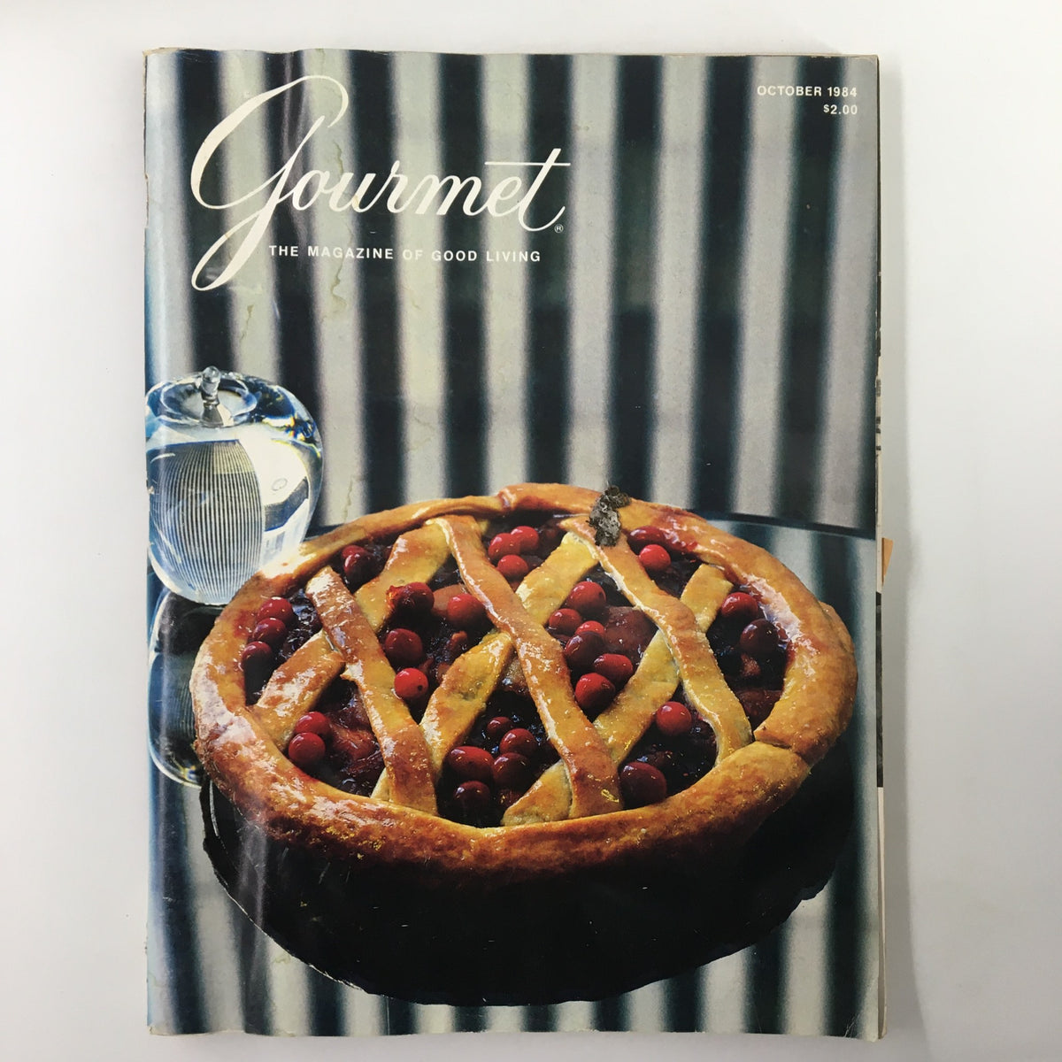 Gourmet Magazine October 1984 cover featuring a delicious pie filled with cranberries, set against a striped backdrop.